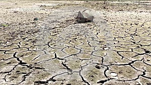 Cracked ground caused by dryness, dehydrated clay soil, ill effects of the dry summer season.