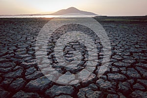 Cracks on the surface of the earth are altered by the shrinkage of mud due to drought conditions of the terrain photo