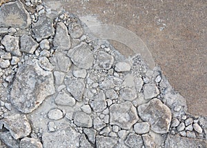 Cracked and grunged road with stone