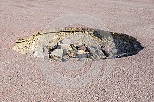 Cracked hole in the asphalt road