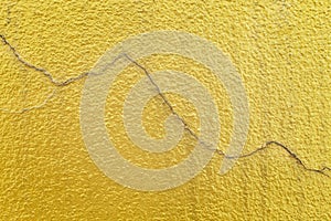 Cracked lines on colorful bright gold paint concrete wall patterns texture abstract for background