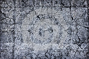 Cracked old concrete wall texture. Broken rough cement surface. Dark gray gloomy grunge abstract background