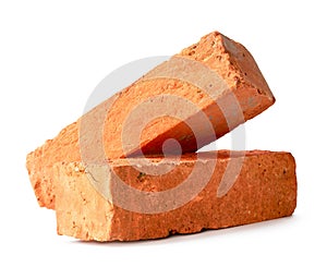 Cracked old red or orange bricks in stack isolated on white background with clipping path