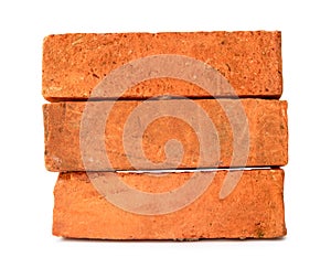 Cracked old red or orange bricks in stack isolated on white background with clipping path
