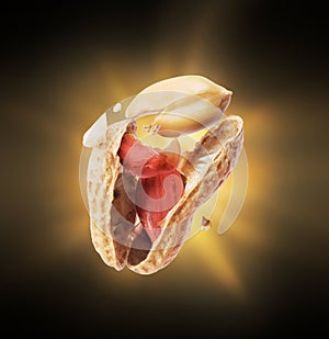 A cracked peanut with a flash of light in the dark