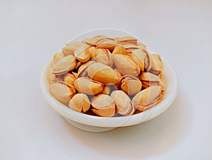 Cracked pistachio nut dry fruit food with shell roasted and salted pistachios in a bowl pista closeup pistacia vera pistache photo