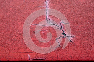 Cracked red paint on grunge metal surface - macro 1