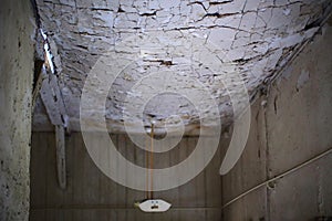 Cracked sagging ceiling in an abandoned building nearly collapsing