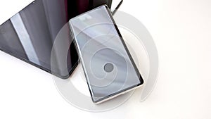 Cracked Screen Smartphone Lying On White Background With Reflection