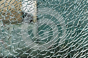 Cracked, shattered glass with urban reflections. Vandalism