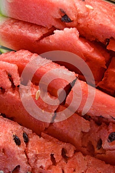 Cracked Sliced pieces of watermelon texture red background.