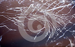 Cracked smart phone screen close-up. Broken glass texture background with cracks