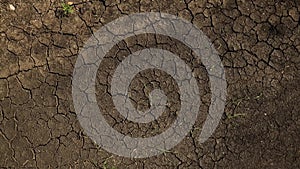 Cracked soil ground of dried lake or river in mountains. Land destroyed by erosion and global warming ecological issues