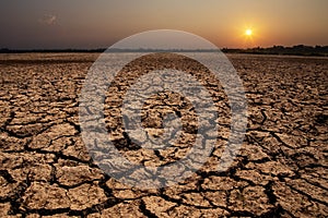 Cracked soil in the summer with the sun. Cracks of the dried soil in arid season at rural Thailand