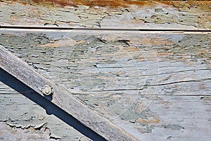 Cracked, splintered, wood wall, gray fading paint, slanted plank, triangle corner