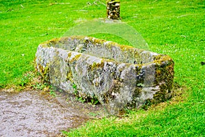 Cracked stone coffin or tomb in churchyard