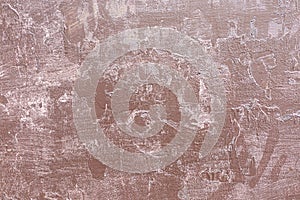 The cracked surface of the concrete wall is a close-up of a neutral color. The old shabby background is light brown.