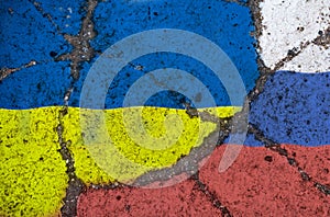 On the cracked texture of the asphalt, images of the flags of Ukraine and Russia are superimposed. ?onfratation symbol