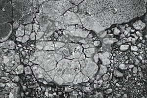 Cracked texture of small gravel stone in a concrete slab cement floor close up