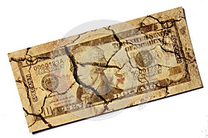 Cracked US paper dollar currency on isolated white