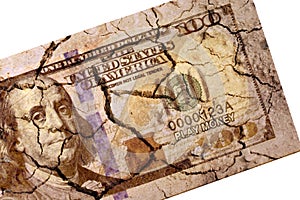 Cracked US paper dollar currency on isolated white