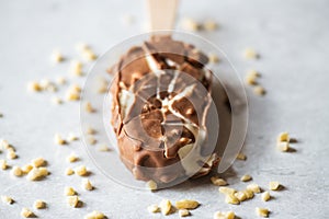 Cracked vanilla almond ice cream with chocolate glaze, close up