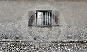 Cracked wall with old wooden window. Stone texture background