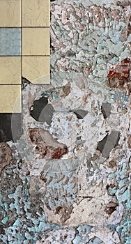 Cracked wall with peeling paint and tiles