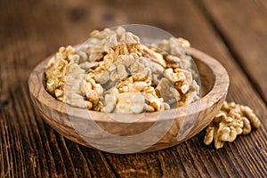 Cracked Walnuts on wooden background selective focus