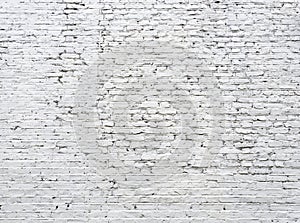 Cracked white brick wall