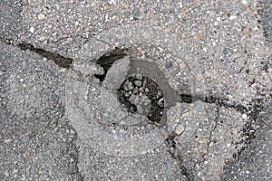 Cracked whole in the asphalt road