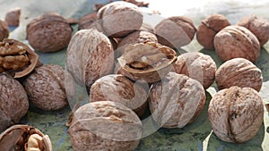 Cracked and Whole Walnut on Old Green Surface