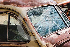 Cracked windshield on old rusty vintage antique car