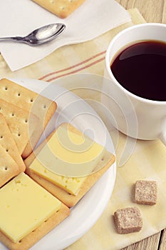 Cracker with cheese and coffee