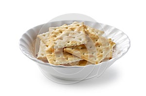 Crackers in a dish placed on a white background