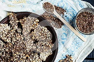 Crackers from flax seed, sesame, sunflower and spices on a dark