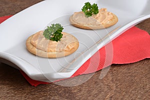 Crackers with salmon pate and parsley