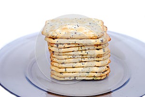 Crackers with seasoning lie on a plate on a white background.