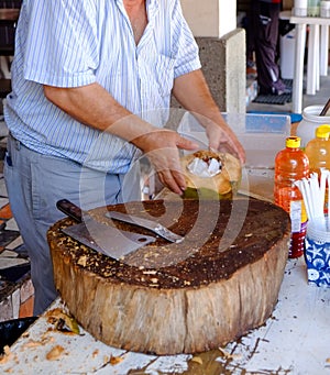 Cracking coconut for handmade pina colada drink Mexico