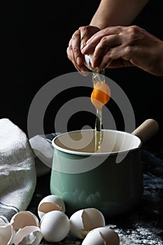 Cracking egg by hands