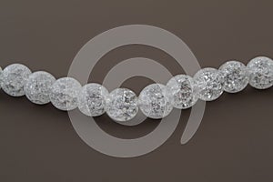 Crackle glass or Sugar quartz beads on a brown background