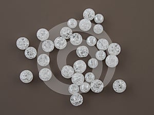 Crackle glass or Sugar quartz beads on a brown background