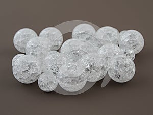 Crackle glass or Sugar quartz beads on a brown background