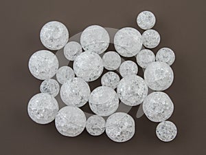 Crackle glass or Sugar quartz beads on a brown background