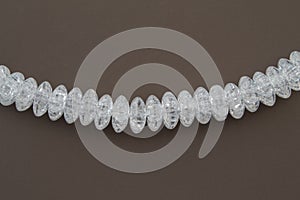 Crackle glass or Sugar quartz beads on a brown background