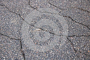Cracks on the asphalt background or texture