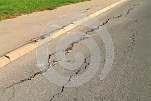 Cracks in the asphalt pavement closeup