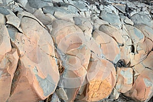 Cracks and colorful layers of sandstone background. A big heap of sandstones, storage space of various natural sandstone. The patt