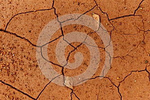 Cracks of the dried soil in arid season / Arid soil , Cracked earth texture of ground broken and rough surface red mud clay