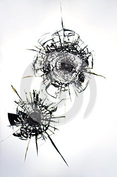 Cracks on the glass from gun shots. Broken shop window after a criminal robbery. Cracks texture for design